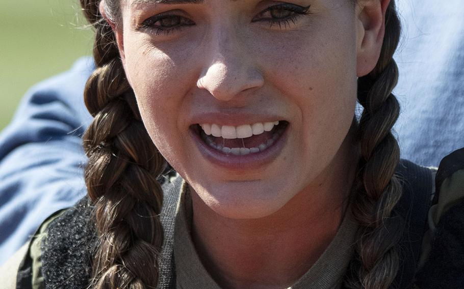 Army Capt. Katie Hernandez catches her breath after setting a world women's record for a mile run in a bomb disposal suit, Saturday, April 3, 2021, at George Mason University in Fairfax, Va.