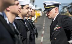 An officer inspects sailors aboard the USS Boxer amphibious assault ship in the Arabian Sea, Sept. 20, 2019. 