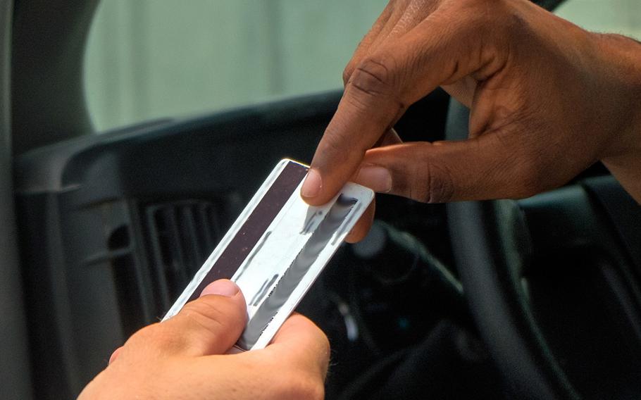 A Common Access Card is returned to an airman in 2017, at an undisclosed location in southeast Asia. The cards are ''vectors of disease,'' said the Army, which is looking for an alternative that uses biometrics.