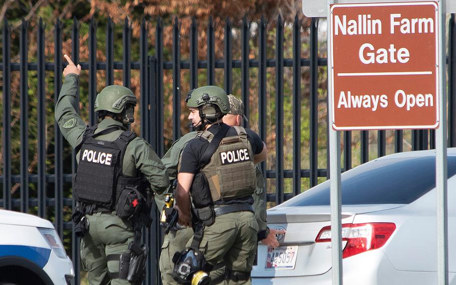 Members of the Frederick Police Department Special Response Team prepare to enter Fort Detrick at the Nallin Farm Gate following a shooting Tuesday, April 6, 2021, in northeast Frederick, Md. Authorities said a Navy medic shot and critically wounded two people at a Maryland business park before fleeing to the Army base, where he was shot and killed.