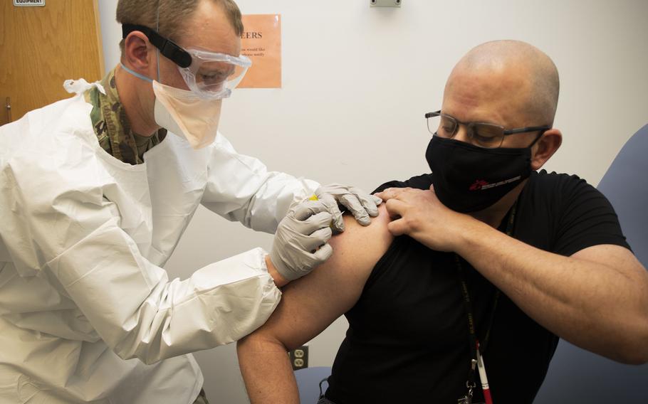 Capt. Aaron Sanborn injects Francis Holinaty on the first day of clinical testing of the Walter Reed Army Institute of Research's spike ferritin nanoparticle (SpFN) vaccine. Pre-clinical studies have found that SpFN induces highly potent  antibody responses against the virus that causes COVID-19 and three major variants.



