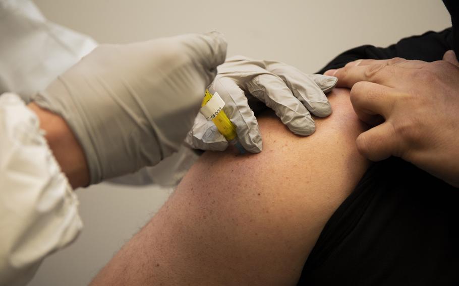 Francis Holinaty receives the first injection of the Walter Reed Army Institute of Research's spike ferritin nanoparticle (SpFN) vaccine at the WRAIR Clinical Trials Center. Pre-clinical studies have found that SpFN induces highly potent  antibody responses against the virus that causes COVID-19 and three major variants.
