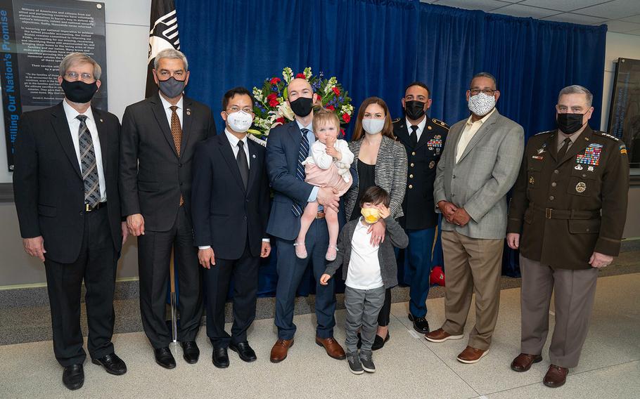 Army Gen. Mark A. Milley, chairman of the Joint Chiefs of Staff, right, and family members of service members killed in the Mi-17 tragedy pose for a group photograph during the Defense POW/MIA Accounting Agency (DPAA) ceremony commemorating the 20th anniversary of the crash, at the Pentagon, April 7, 2021. 