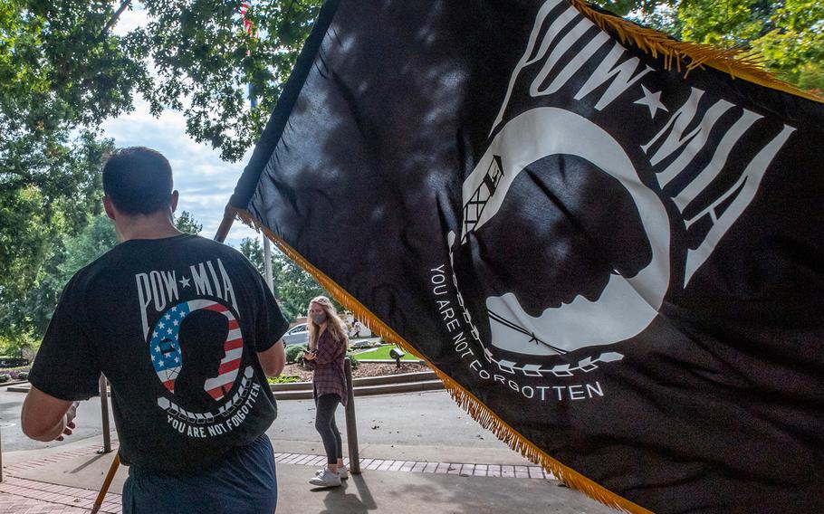 An ROTC cadet at Clemson University, S.C., carries a POW/MIA flag during an honor run Oct. 16, 2020.
