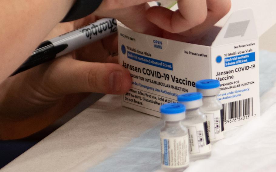 An airman from the 18th Medical Group numbers vials of the Janssen coronavirus vaccine, commonly known as the Johnson & Johnson vaccine, at Kadena Air Base, Japan, on April 13, 2021.