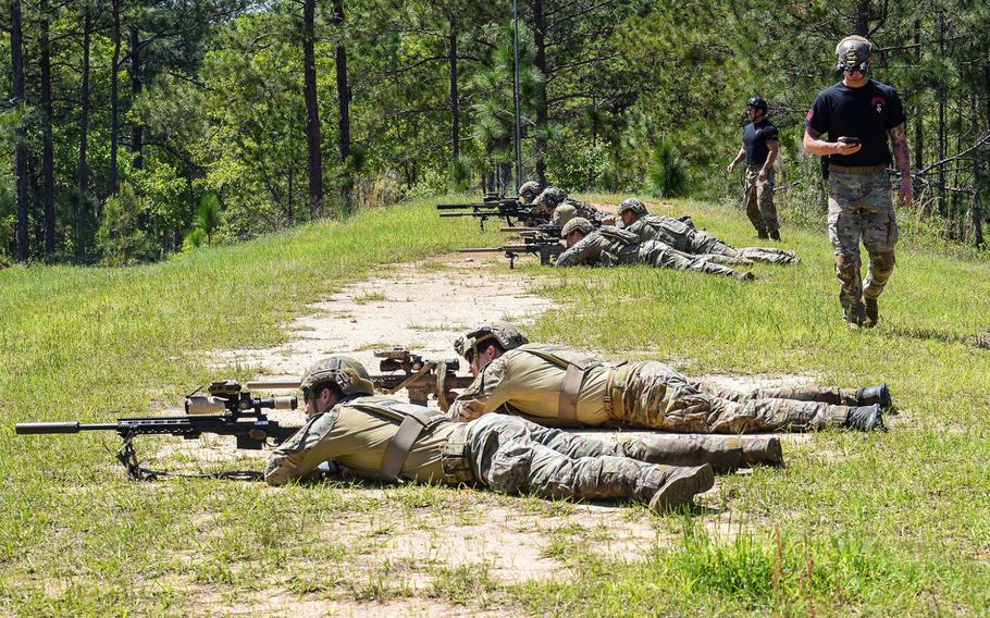 Army Sniper School cadre look on as snipers compete in the heartbreaker event during the Best Sniper competition at Fort Benning in Georgia on Monday, April 12, 2021.