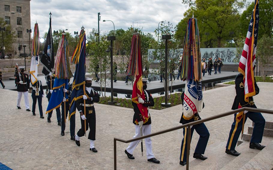 Members of a military ceremonial honor guard march off followed by members of the U.S. Army Band "Pershing's Own" at the conclusion of a dedication ceremony for the World War I Memorial in Washington, D.C. on Friday, April 16, 2021.