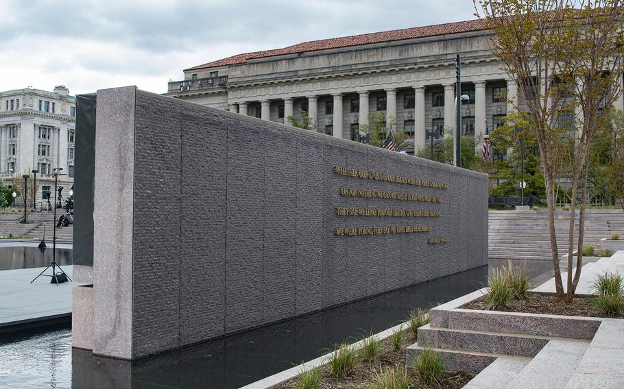 A granite wall with a quote from American poet and WWI veteran Archibald Macleish, stands in a reflecting pool at the new World War I Memorial in Washington, D.C., where a dedication ceremony took place for the site on Friday, April 16, 2021. The words read in part: “We were young, they say. We have died. Remember us.”