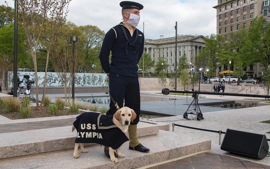 Tom Frezza and his dog Shea wear World War I-era uniforms on Friday, April 16, 2021, at a dedication ceremony for the new WWI Memorial in Washington, D.C.