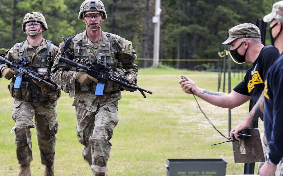 Ranger instructors time competitors as they complete the Urban Assault Course portion of the Army's 2021 Best Ranger Contest at Fort Benning, Ga. on April 16, 2021.