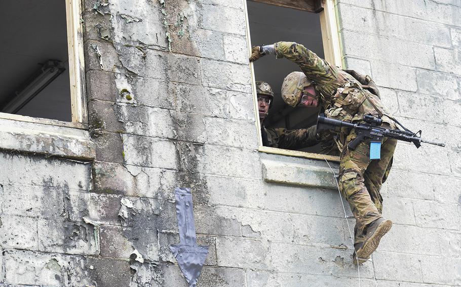 Best Ranger competitors climb out a window on Fort Benning, Ga.'s Urban Assault Course on the first day of 2021 competition consider among the Army's most grueling challenges.