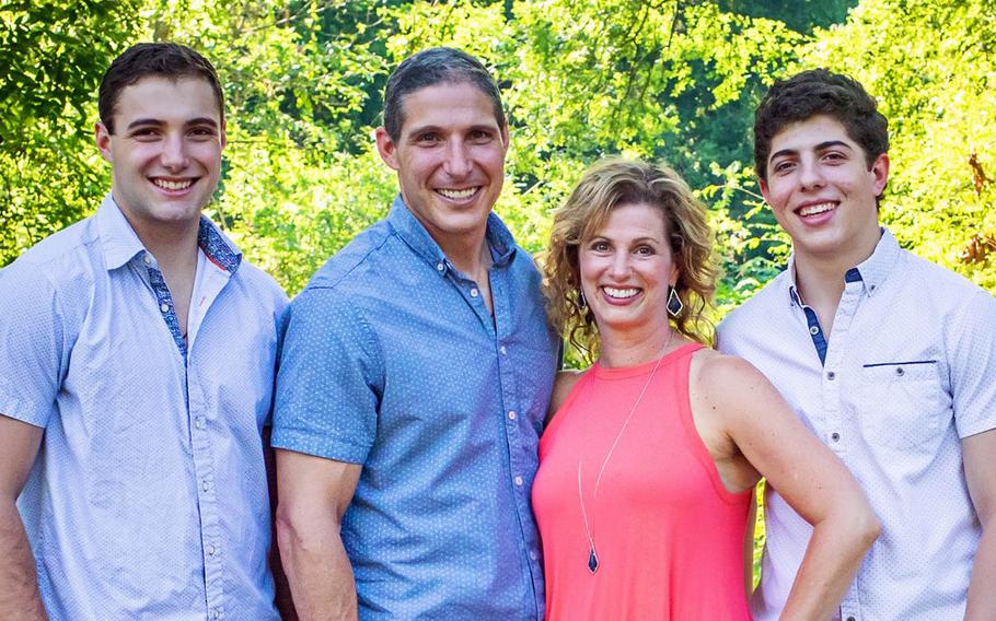 The first member of the Space Force to leave the Earth, Col. Mike Hopkins, poses with his wife, Julie, and sons Ryan and Lucas.
