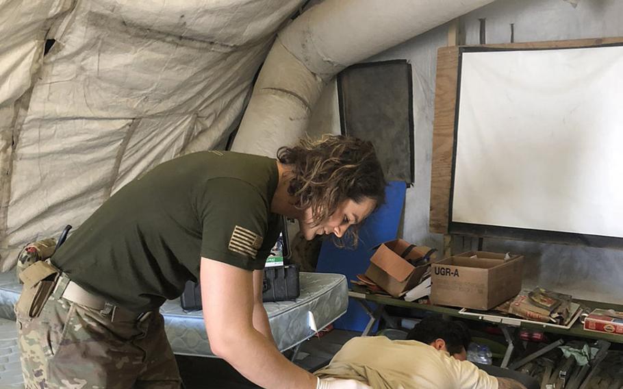 Then-Capt. Alivia Stehlik, a transgender service member, provides physical therapy for a soldier while deployed to Afghanistan in 2018. 

