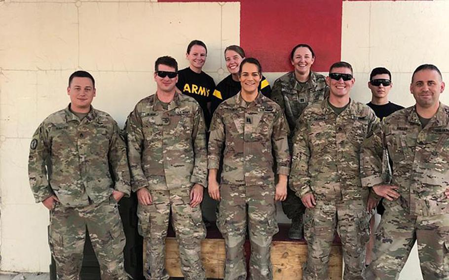 Then-Army Capt. Alivia Stehlik, front row center, stands with other medical staff during her deployment to Afghanistan in 2018. 