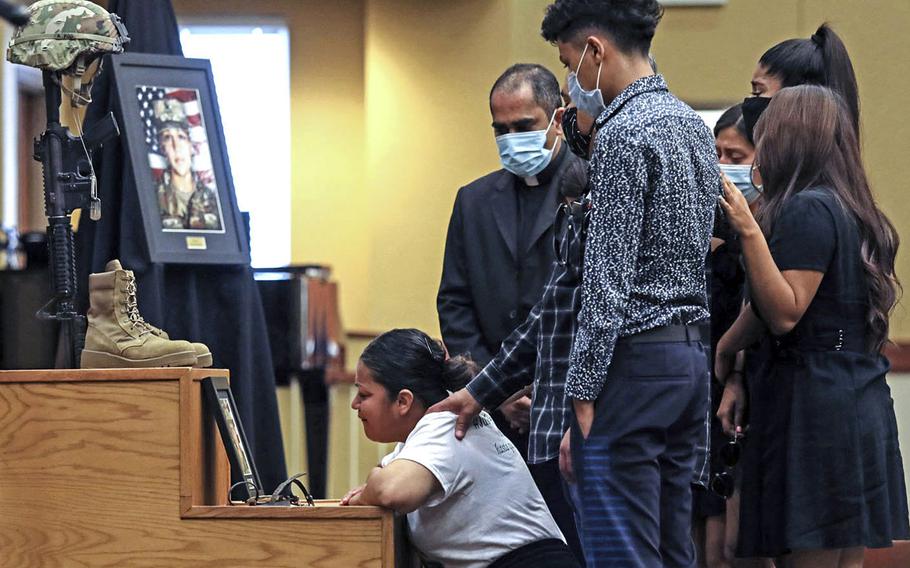 The family of Spc. Vanessa Guillen grieves in front of her Soldier’s Cross during her unit memorial ceremony at Fort Hood, Texas, on July 17. Several hundred people — family, friends and fellow soldiers — attended the ceremony in the post’s Spirit of Fort Hood Chapel.