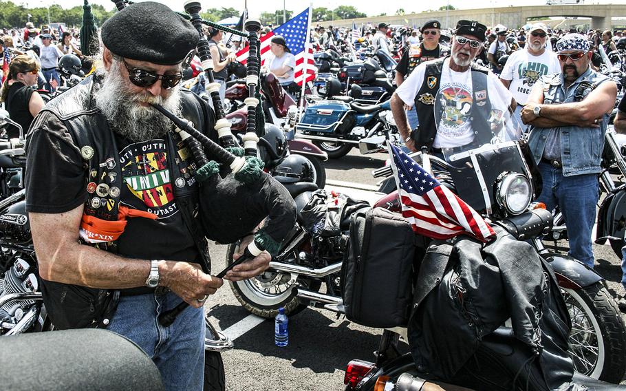 In a 2006 photo, a bagpiper plays as he walks between motorcycles in a Pentagon parking lot before the annual Rolling Thunder rally.