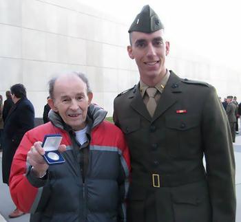 Jack Zovack, left, holds up the silver coin he was given by his nephew, then 2nd Lt. Patrick Weeks, right, at Weeks' commissioning as a U.S. Marine Corps officer at Quantico, Va., Dec. 11, 2009. Zovack, who served in the Pacific in WWII and in the Korean war, gave Weeks his first salute.
