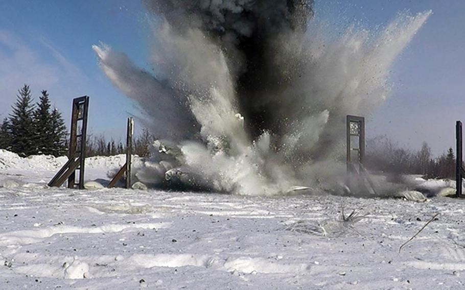 An explosive charge detonates at Eielson Air Force Base, Alaska, March 18, 2021, during an experiment to see if snow-filled bags can be used to dampen shockwaves from such blasts.