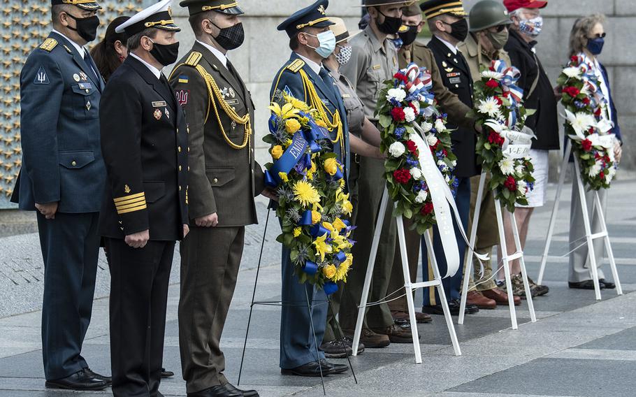 Veterans and other wreath-layers pose during a ceremony at the National World War II Memorial in Washington, D.C. on May 8, 2021, the anniversary of the end of the war in Europe.