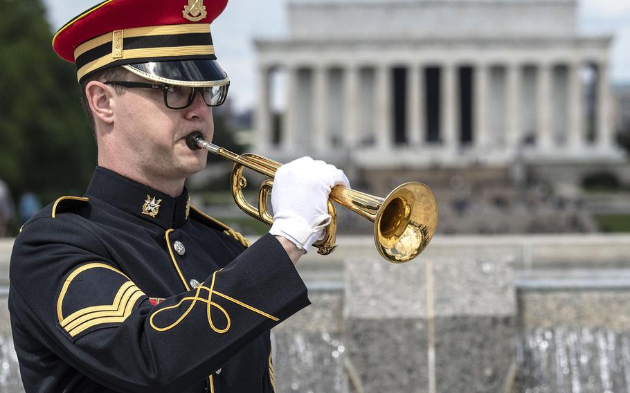 Staff Sgt. Andrew Boylan of Houston, Texas, a member of the U.S. Army Band, plays taps during a ceremony at the National World War II Memorial in Washington, D.C. on May 8, 2021, the anniversary of the end of the war in Europe.