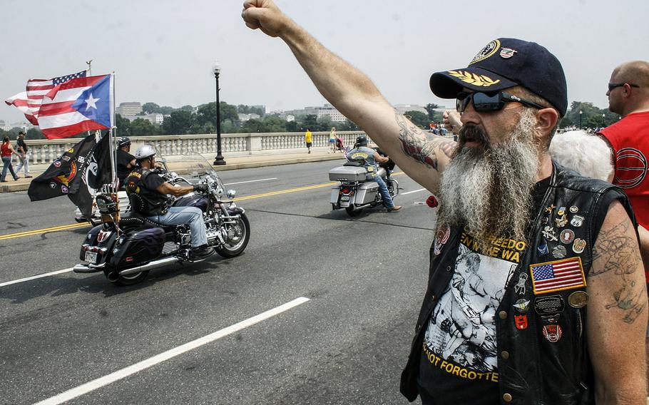 In a May, 2007 photo, a spectator cheers Rolling Thunder riders along as they cross into the District of Columbia.