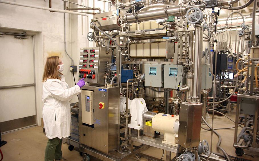 Anna Crumbley, a research chemical engineer, removes the solids from a new batch of fermented microorganisms, May 11, 2021 at Aberdeen Proving Ground, Md. The Chemical Biological Center is working on using bacteria to make missile propellant, among other applications. 

