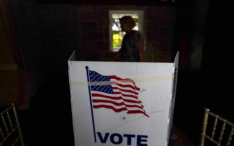 A person waits in line to vote in the Georgia’s primary election on May 24, 2022, in Atlanta.