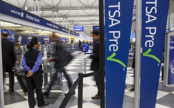Passengers walk through the entrance of a TSA PreCheck in at O'Hare International Airport in 2017 in Chicago. 