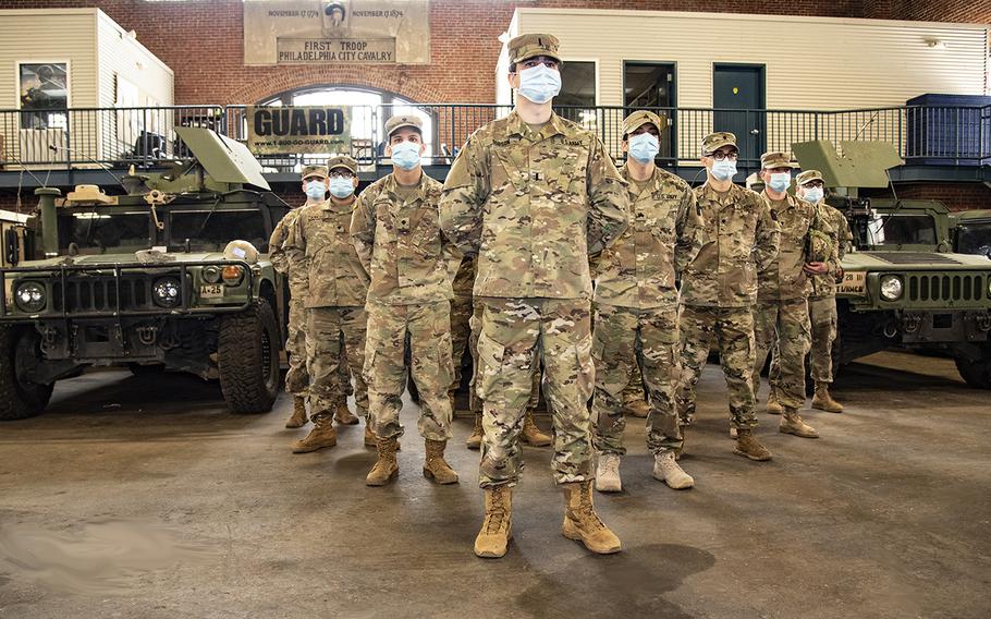 The officer in charge of Task Force Saber, 1st Lt. Scott Dobson, stands with a few of the Pennsylvania National Guard mortuary affairs and fatality search and recovery team at the 1st City Troop National Guard Armory in Center City Philadelphia on April 25, 2020.