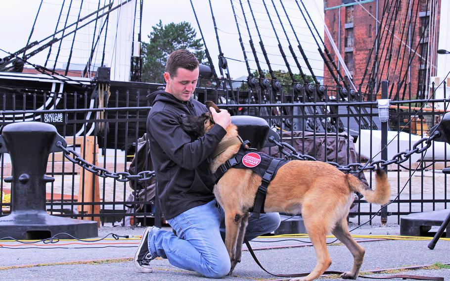 Brendan Cabey reunites with his first military working dog, Ramos, that he adopted with the help of American Humane. The ceremony took place in front of the USS Constitution in Boston on Sept. 11, 2020.