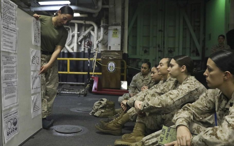 U.S. Marines discuss a female engagement team training schedule on the deck of the Wasp-class amphibious assault ship USS Kearsarge on March 4, 2019. The National Commission on Military, National and Public Service recommended in a report to the Pentagon, White House and Congress that selective service registration should be extended to women.
