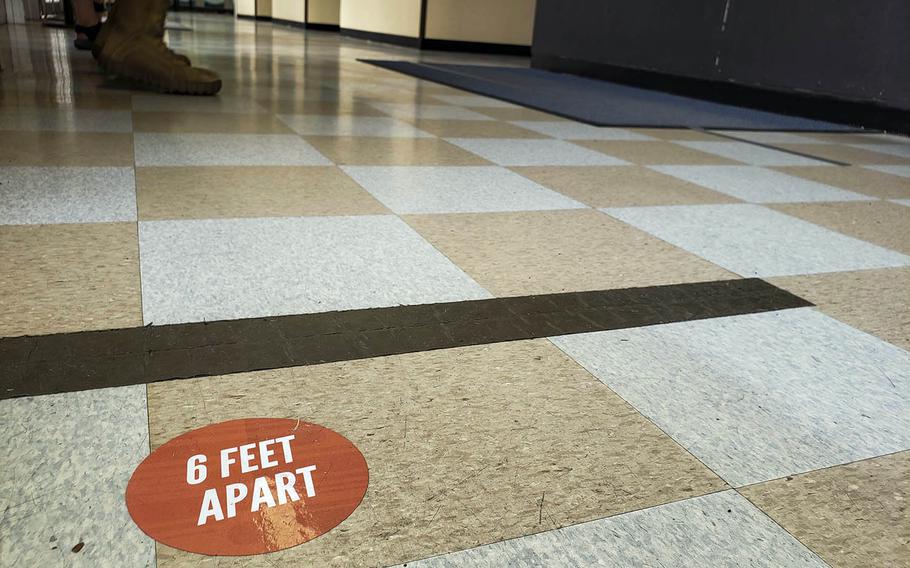 A floor decal inside the post office at Yokota Air Base in western Tokyo encourages social distancing, March 27, 2020. 