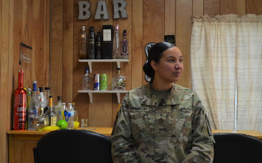 Sgt. 1st Class Crystal Basham, the lead sexual assault response coordinator for the 1st Cavalry Division at Fort Hood, Texas, stands in a mock bar where soldiers act out scenarios to learn how to identify sexual assault and harassment and then intervene safely.  