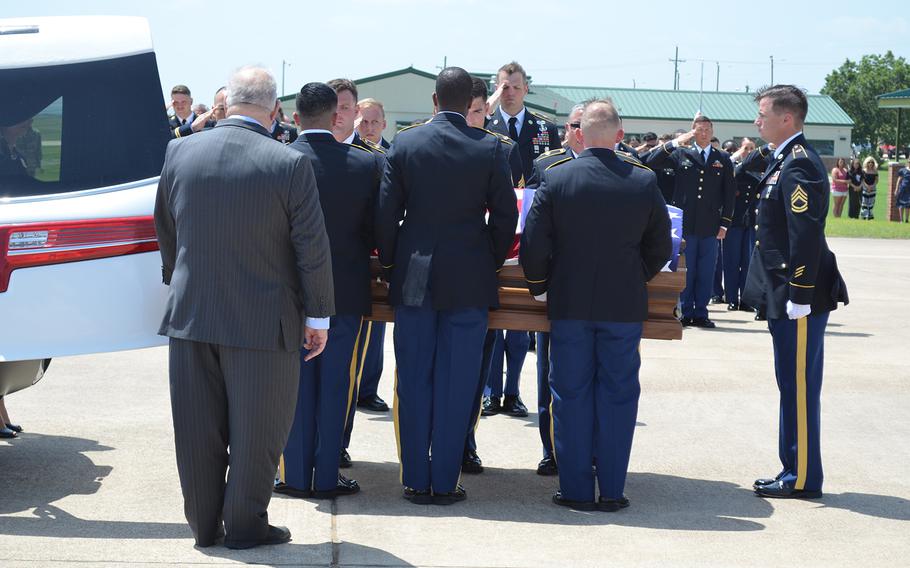 The flag-draped casket carrying the remains of Sgt. James G. Johnston, who died in combat June 25 in Afghanistan, is placed in a hearse during a ceremony Friday at Robert Gray Army Airfield at Fort Hood, Texas.