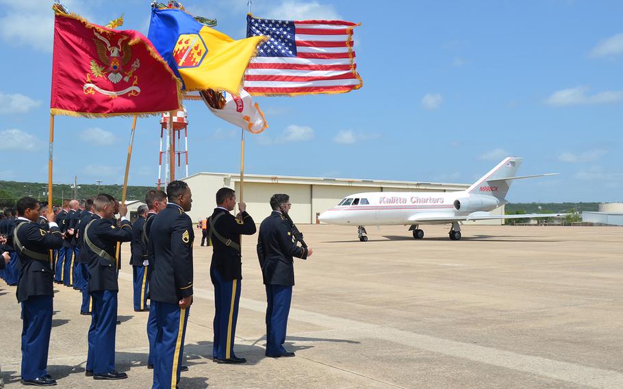 A color guard stands at attention Friday as the plane carrying the remains of Army Sgt. James G. Johnston, who died in combat June 25 in Afghanistan, arrives at Fort Hood, Texas.