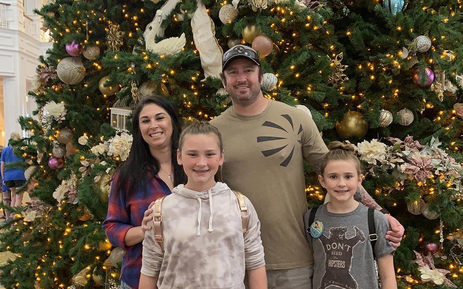 Green Beret Sgt. 1st Class Rich Stayskal poses with his family during a trip to Disney World in November, 2018, during a break in treatments. Stayskal is battling metastatic stage IV lung cancer after military doctors failed to diagnose him for months. From left, wife Meg, and daughters  Addisyn, 11, and Carly, 10.