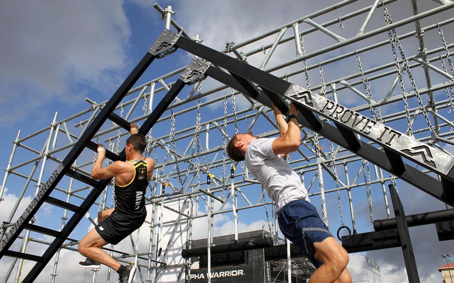 Army Lt. Col. Eric Palicia, left, and Air Force Capt. Noah Palicia, who are brothers, will compete against other members of their service branches Thursday in the Alpha Warrior competition at Retama Park near San Antonio. Each traveled more than 20 hours from overseas bases to compete on the 32-obstacle course.