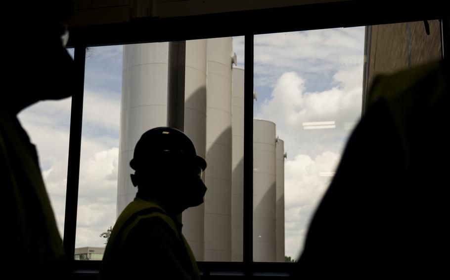 Silos filled with liquid carbon dioxide for making dry ice are next to Pfizer's manufacturing facility in Kalamazoo, Mich. 