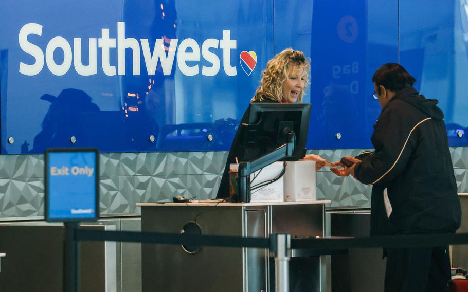 Southwest Airlines worker assists customers at Dallas Love Field airport on Jan. 4, 2023, in Dallas. 