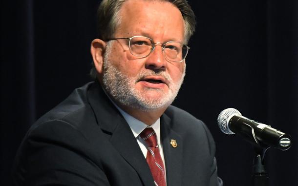 A man speaks in a room. 