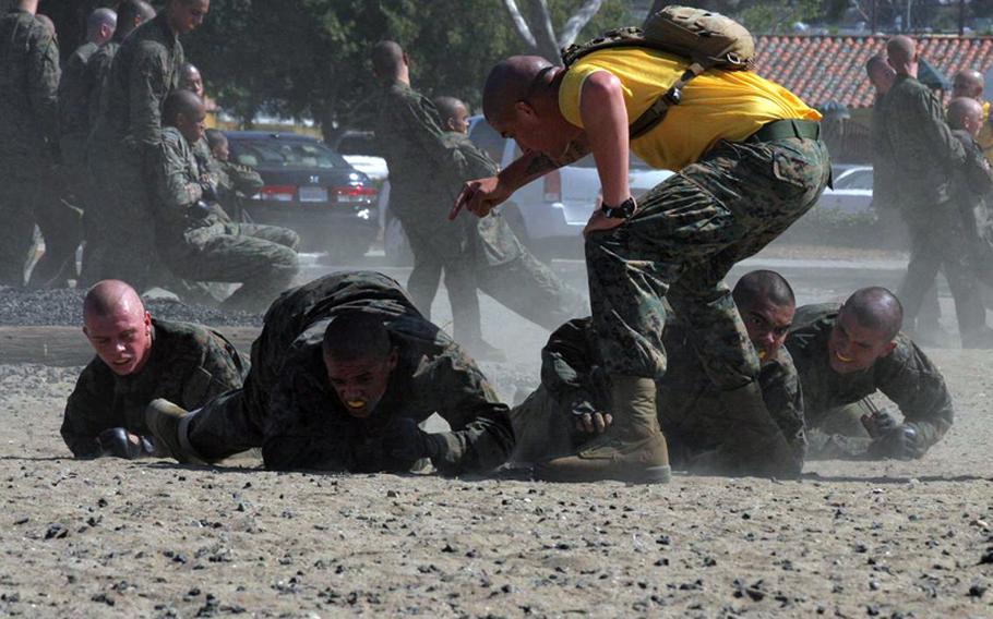 Marine recruits crawl through dust during pre-combat training Aug. 13, 2010, at Marine Corps Recruit Depot San Diego. Defense Secretary Robert Gates inspected the recruits and presided over the graduation of the previous class.