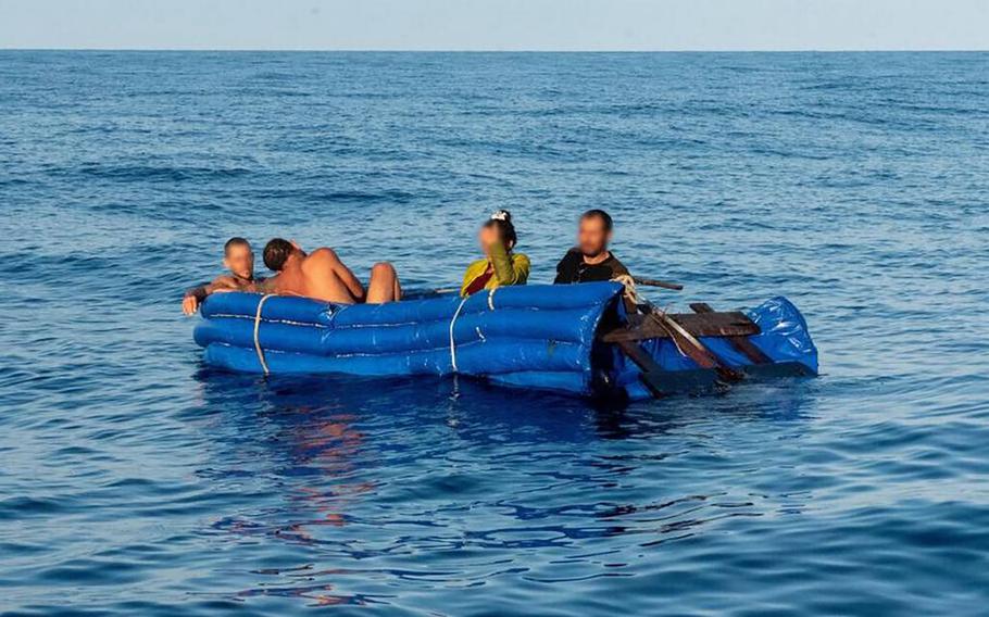 Four people sit on a makeshift migrant raft floating off Big Pine Key Dec. 21, 2022. Similar vessels are a common sight off the Florida Keys, which is the end point in the largest maritime exodus form Cuba in almost 10 years. The Coast Guard stopped a migrant boat with about 20 people on board Wednesday, Dec. 28, 2022. 