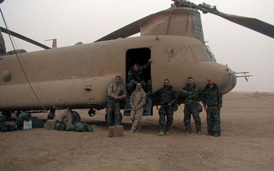 The crew of one of the three stricken Chinook helicopters poses after their safe landing. They are (from left) Sgt. Lance Reynolds, 29, the flight engineer; Staff Sgt. Michael O'Keefe, 33, the door gunner; Chief Warrant Officer 2 Randy Summerlin, 31, the jump-seat pilot; Chief Warrant Officer 3 Dan Helus, 37, the pilot-in-command; Chief Warrant Officer 2 Clay Rekow, 27, the right-seat pilot; and Sgt. Kevin Ellison, 26, the crew chief.