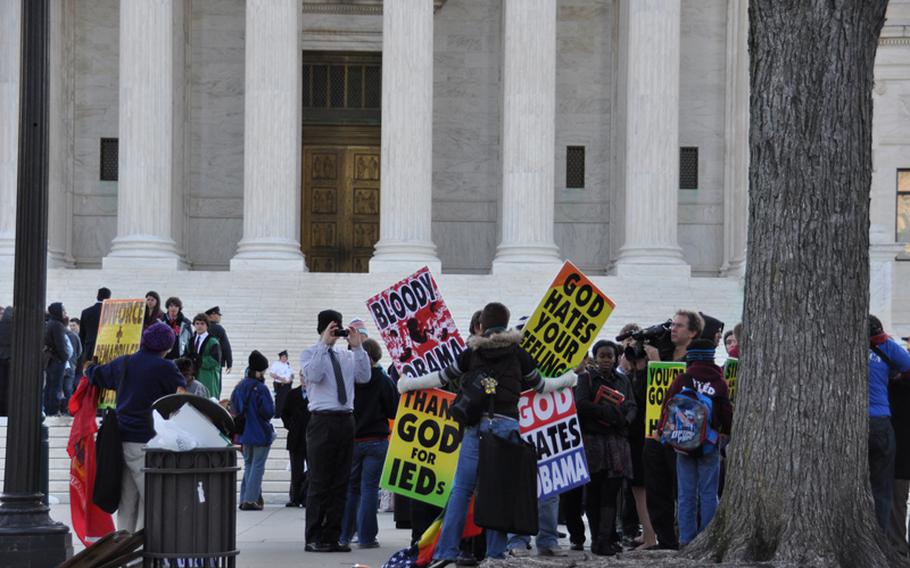 Members of the Westboro Baptist Church demonstrate outside the U.S. Supreme Court on Wednesday in advance of legal arguments related to their protest of a Marine's funeral in 2006.