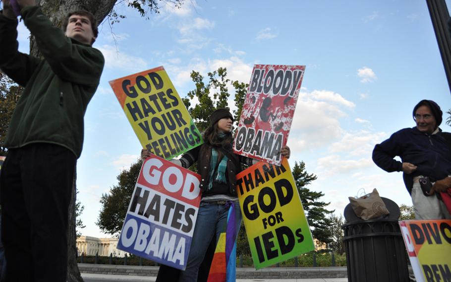 Members of the Westboro Baptist Church demonstrate outside the U.S. Supreme Court on Wednesday in advance of legal arguments related to their protest of a Marine's funeral in 2006.