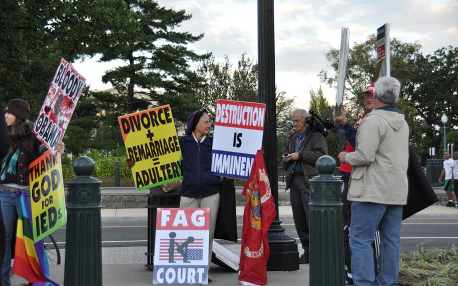 Members of the Westboro Baptist Church demonstrate outside the U.S. Supreme Court on Wednesday in advance of legal arguments related to their protest of a Marine's funeral in 2006.