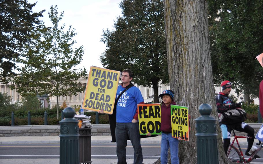 Members of the Westboro Baptist Church demonstrate outside the U.S. Supreme Court on Wednesday in advance of legal arguments related to their protest of a Marine's funeral in 2006.