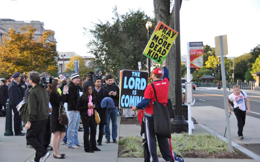 Members of the Westboro Baptist Church demonstrate outside the U.S. Supreme Court on Wednesday in advance of legal arguments related to their protest of a Marine's funeral in 2006.