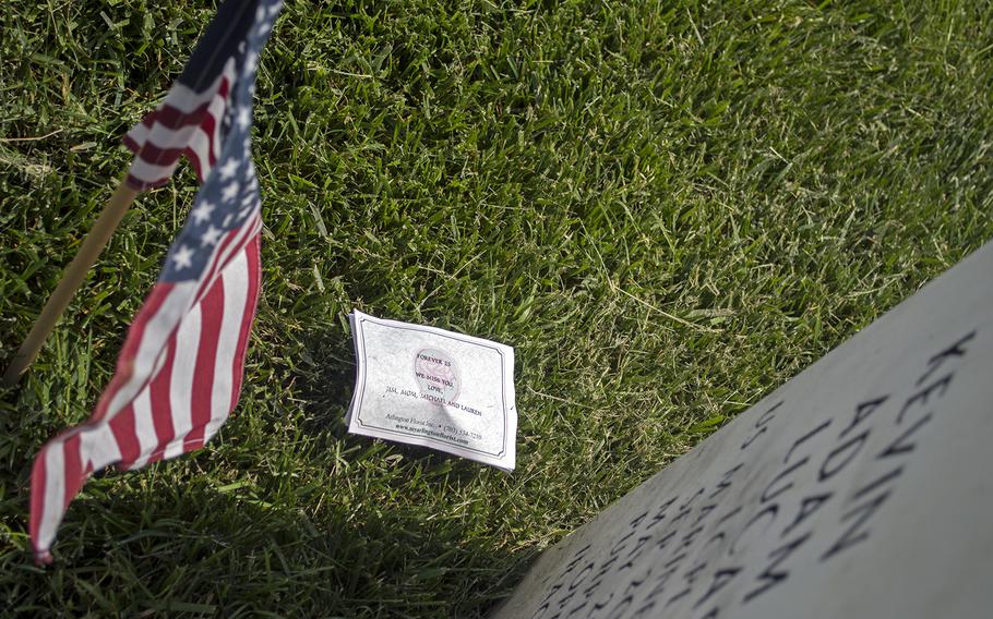 Flags shared space with artifacts and tributes left at the tombstones by family and friends.