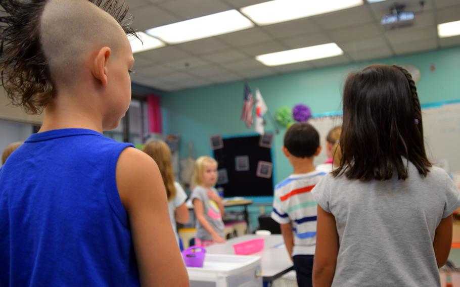 Osan American Elementary School students say the Pledge of Allegiance at Osan Air Base, South Korea, on Aug. 25, 2014.